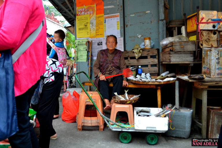 A lady looks on to sell her dried goods in Tai-O village